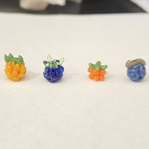 Four One Piece Devil Fruit inspired borosilicate glass bead art sculptures